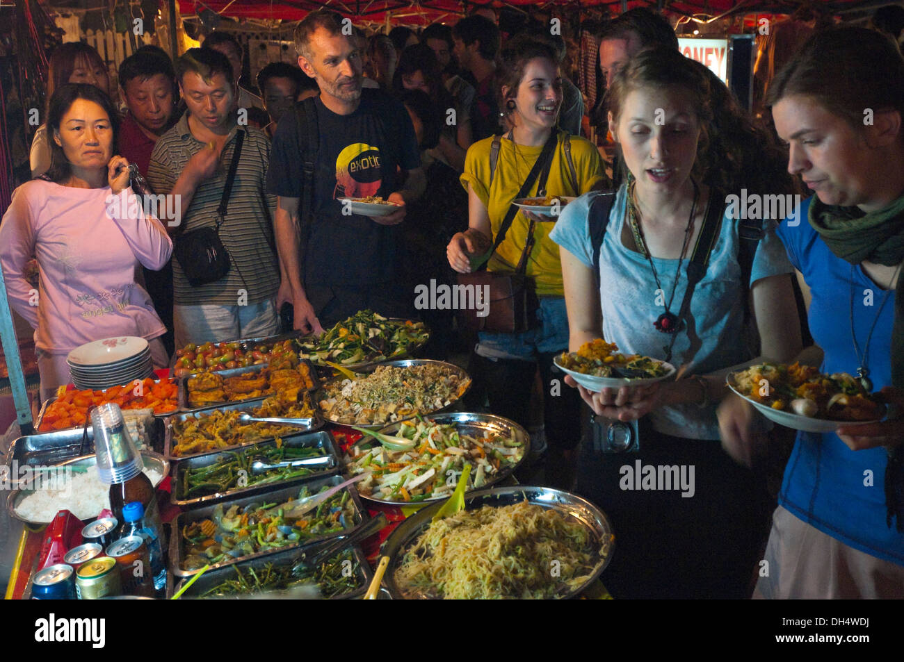 Horizontal close up of a busy 'all you can eat' buffet at night in Laos. Stock Photo
