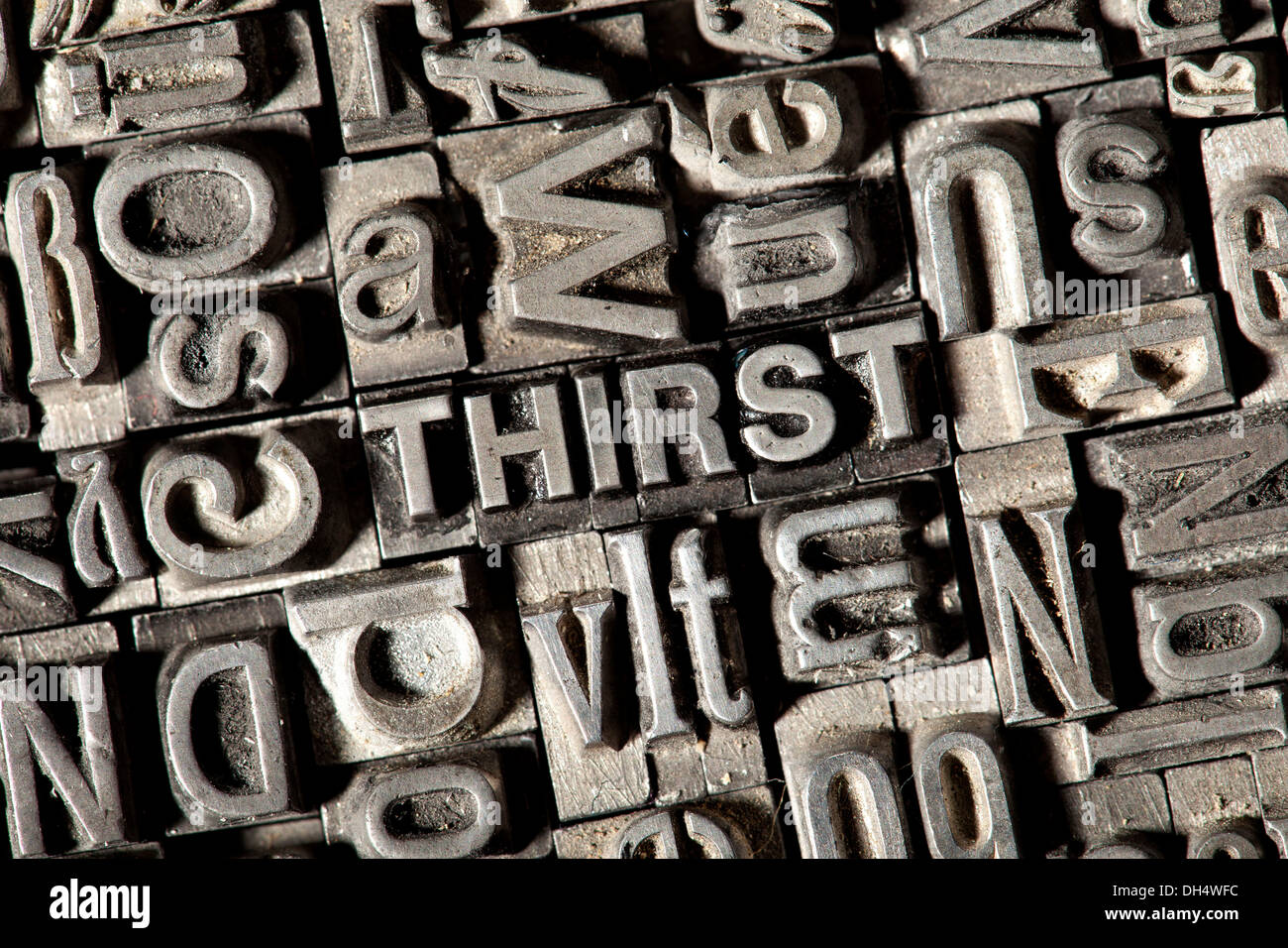 Old lead letters forming the word THIRST Stock Photo
