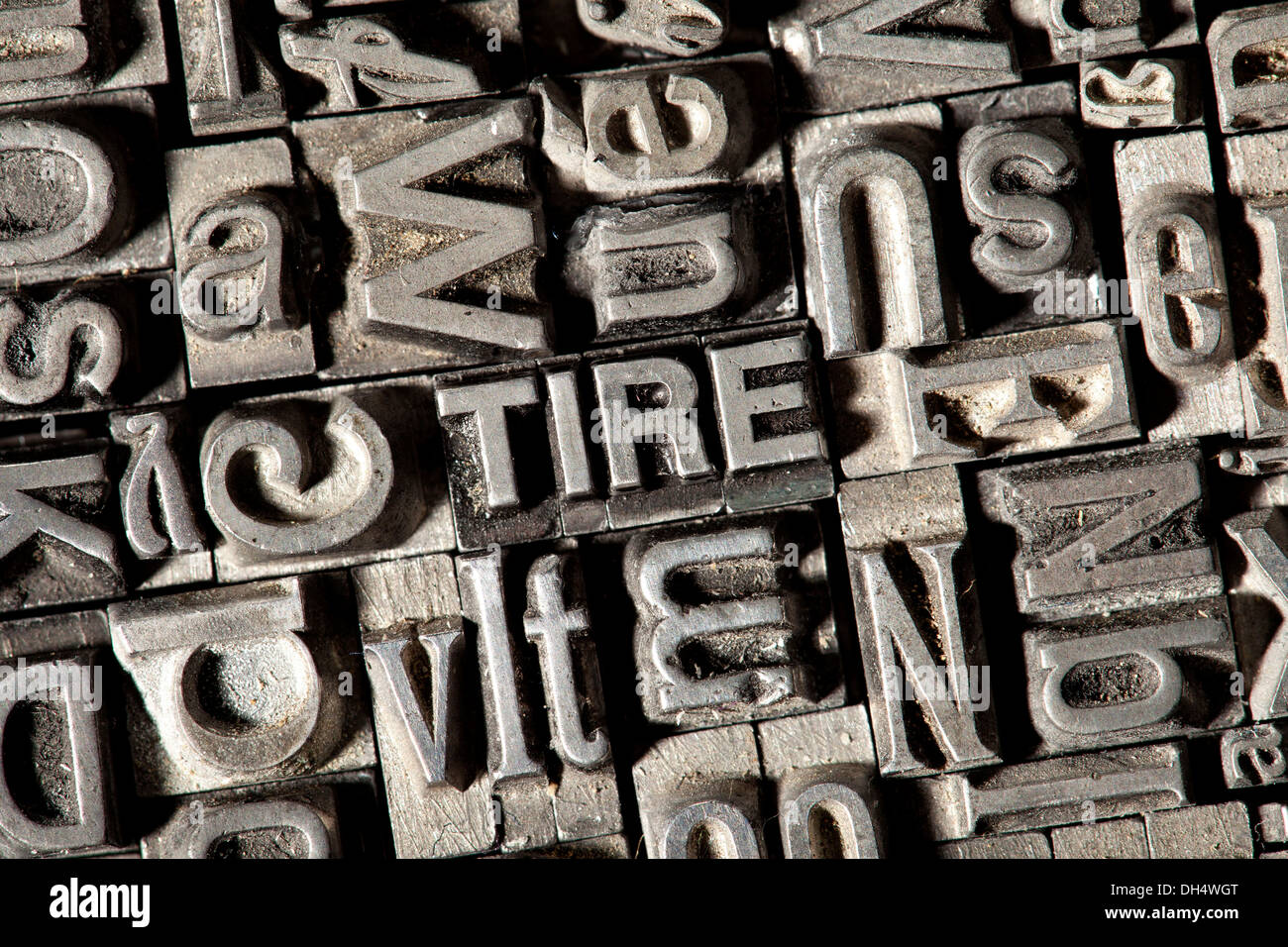 Old lead letters forming the word TIRE Stock Photo