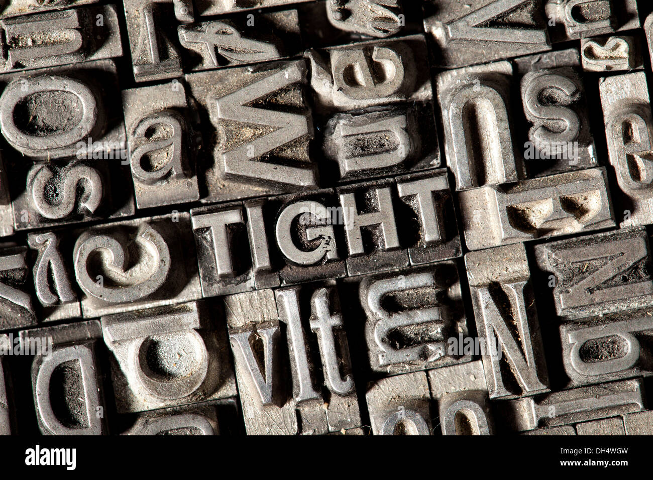 Old lead letters forming the word TIGHT Stock Photo