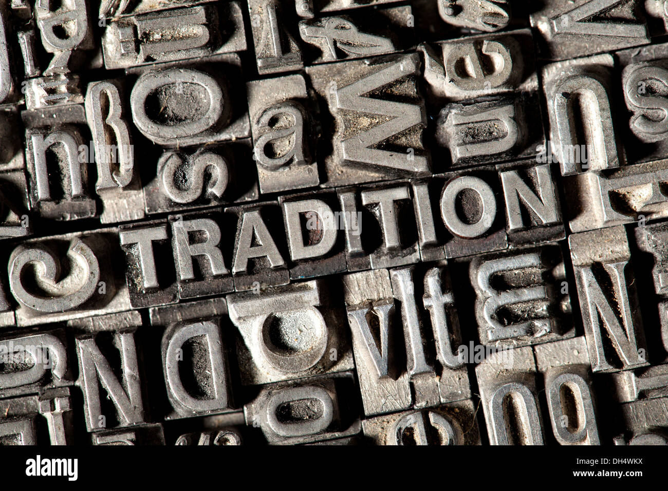 Old lead letters forming the word TRADITION Stock Photo