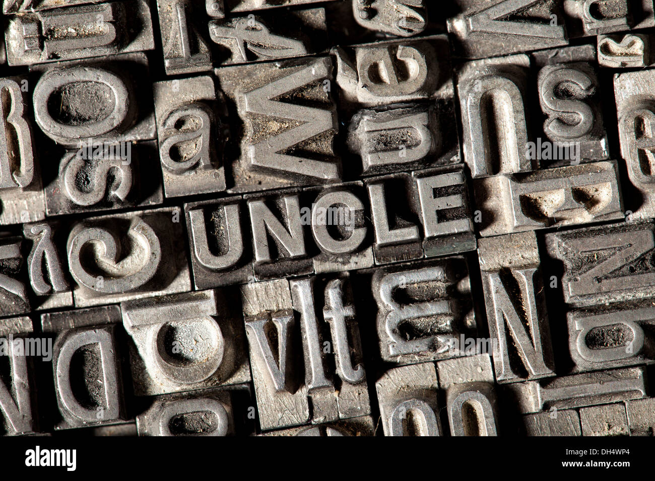 Old lead letters forming the word UNCLE Stock Photo