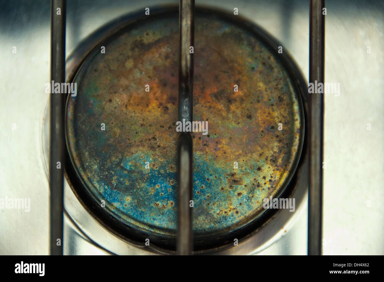 Horizontal close up of the colours on the top of a gas stove. Stock Photo