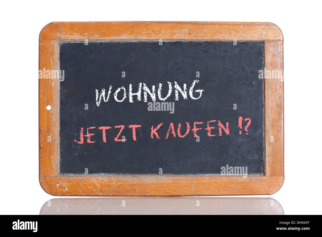 Old school blackboard with the words WOHNUNG JETZT KAUFEN!?, German for Buy an apartment now!? Stock Photo