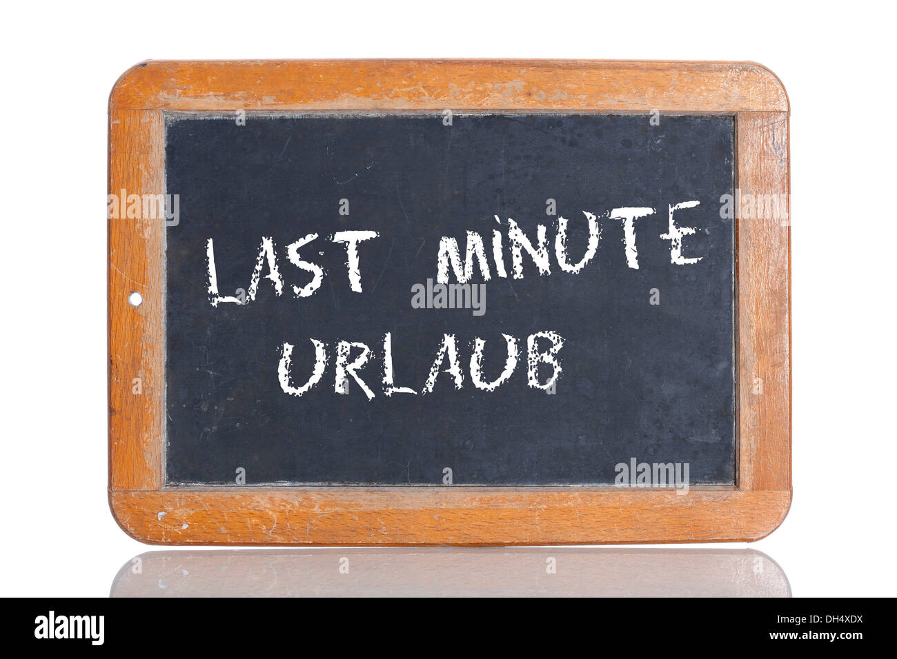Old school blackboard with the words LAST MINUTE URLAUB, German for Last minute holiday Stock Photo