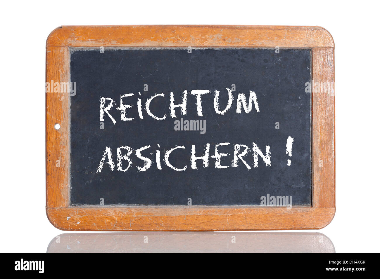 Old school blackboard with the words REICHTUM ABSICHERN!, German for Provide security for your wealth! Stock Photo