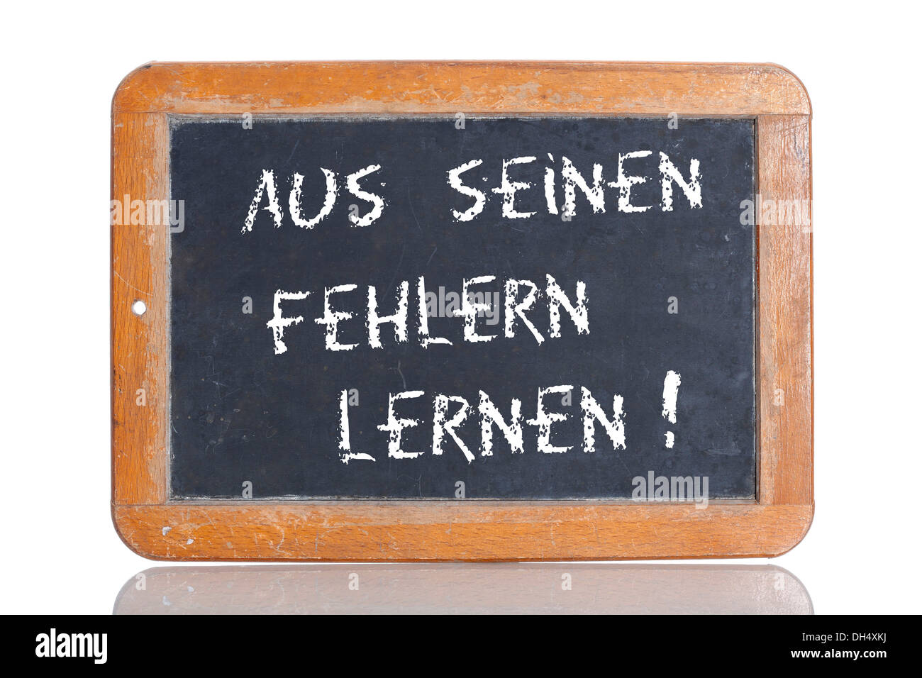 Old school blackboard with the words AUS SEINEN FEHLERN LERNEN!, German for Learn from his mistakes! Stock Photo