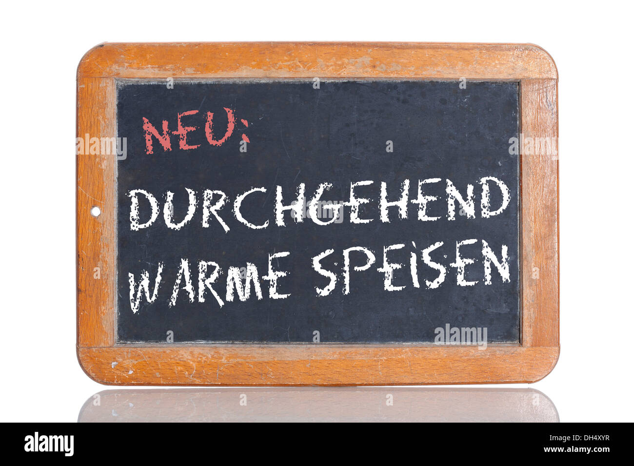 Old school blackboard with the words NEU: DURCHGEHEND WARME SPEISEN, German for New: Warm meals served all day Stock Photo