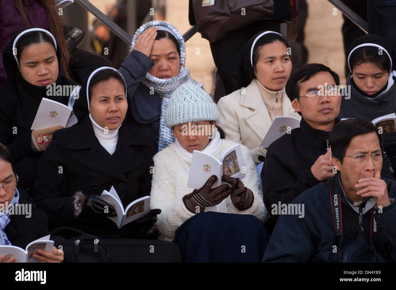 Nuns and priests pray in Saint Peter's square Stock Photo