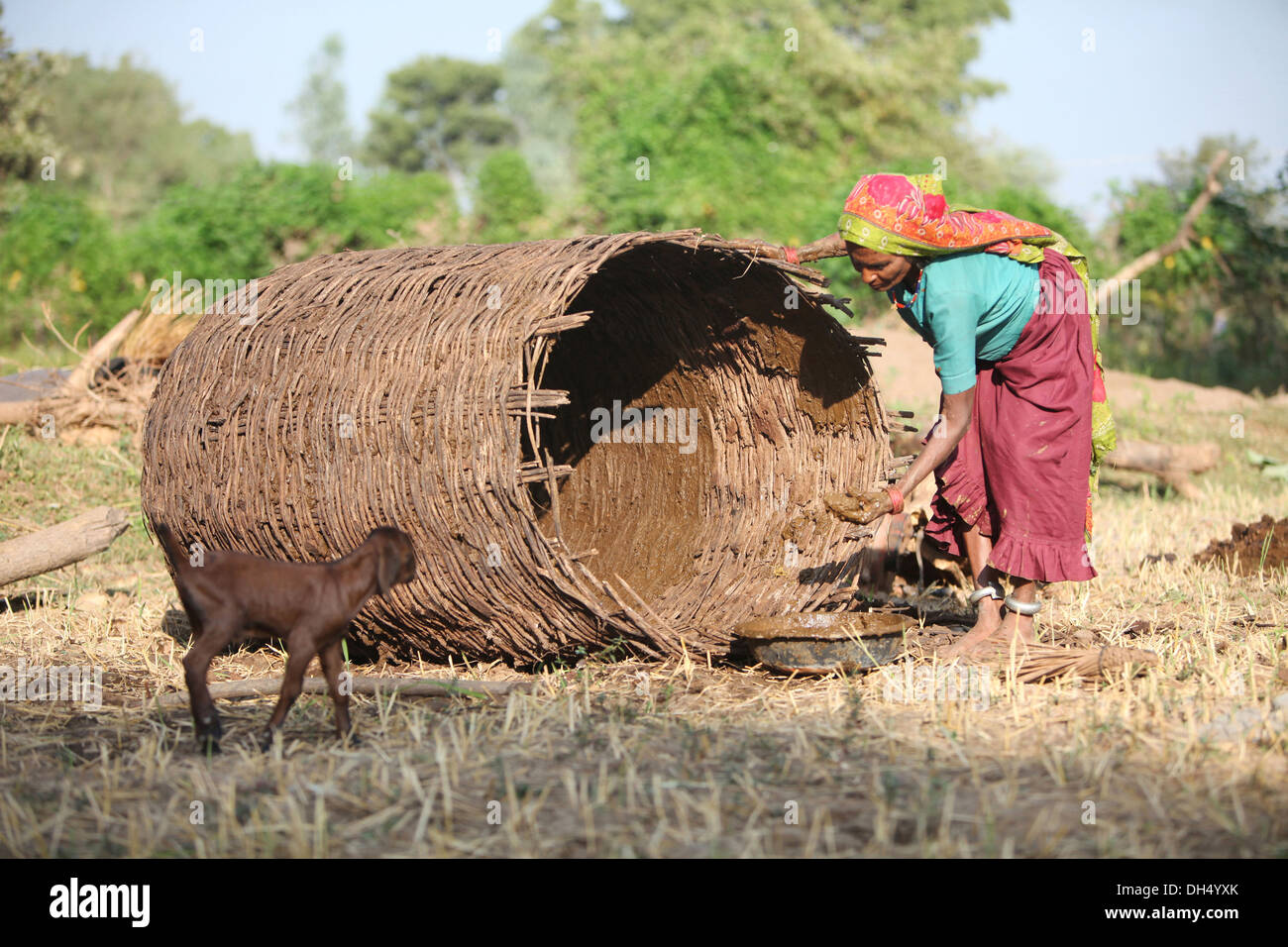 Bhil woman making basket for grain storage, Bhil Tribe, Madhya Pradesh
