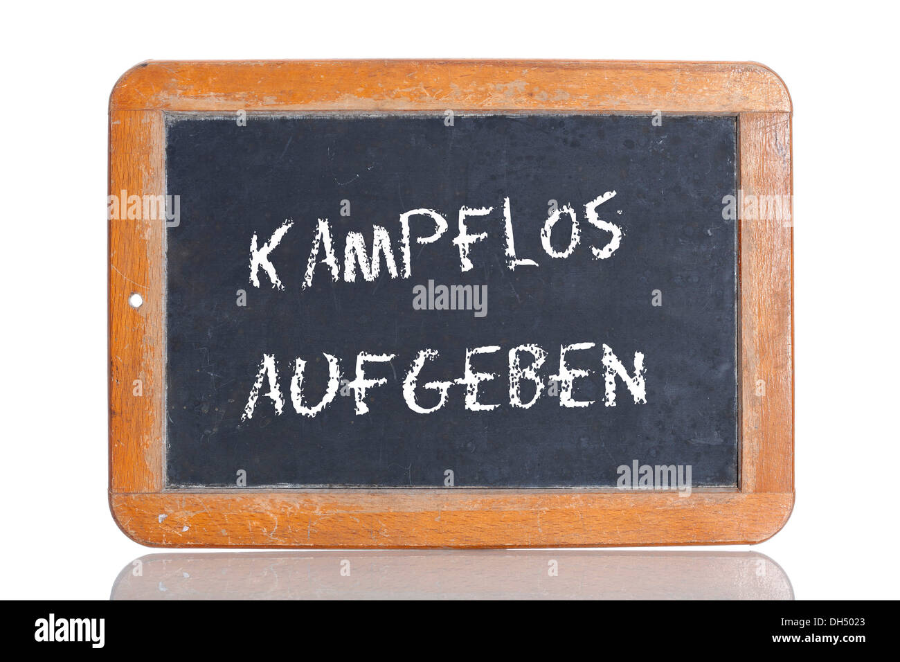 Old chalkboard, lettering 'KAMPFLOS AUFGEBEN', German for 'SURRENDER WITHOUT A FIGHT' Stock Photo