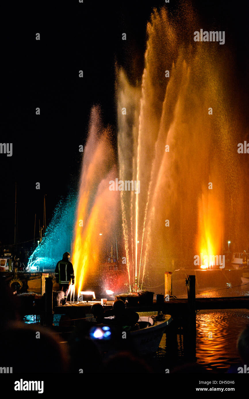 Colourful illuminated fountains at the Harbour Festival in Maasholm, Schleswig-Holstein Stock Photo
