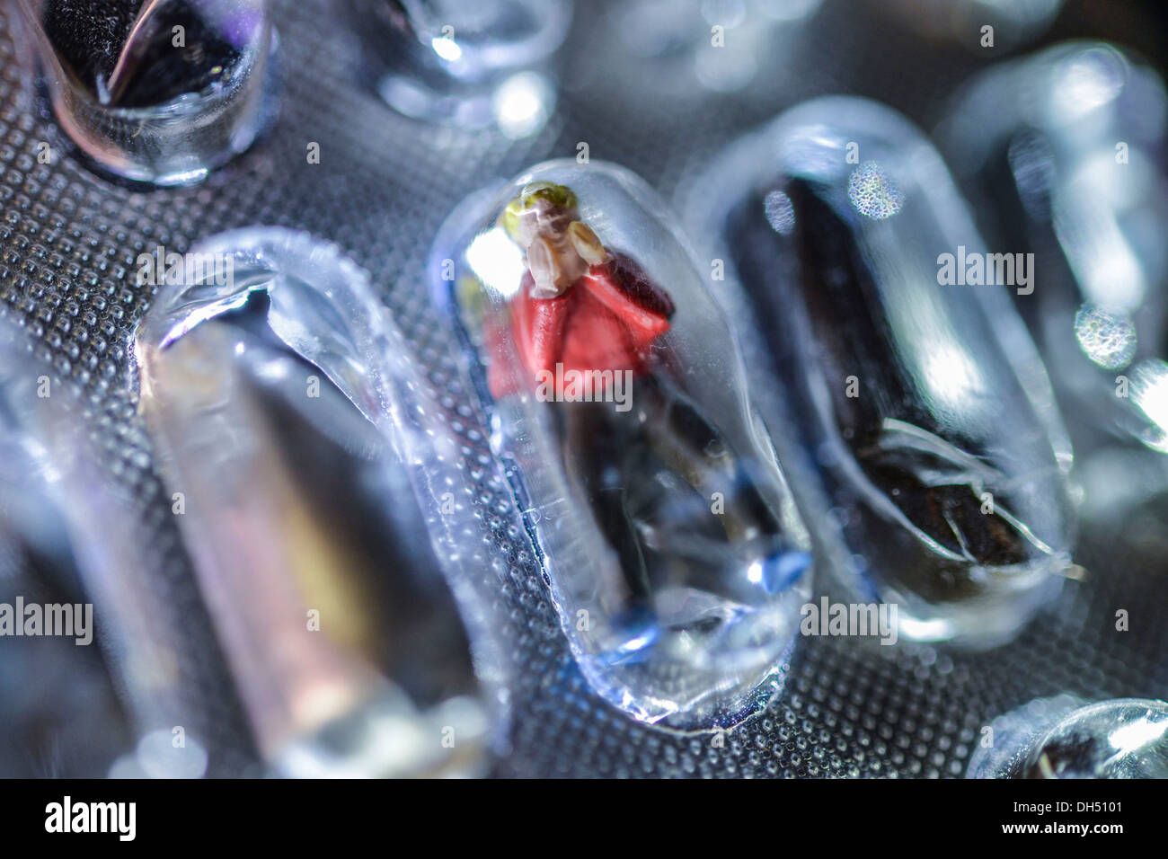Miniature figure in a blister pack of tablets Stock Photo