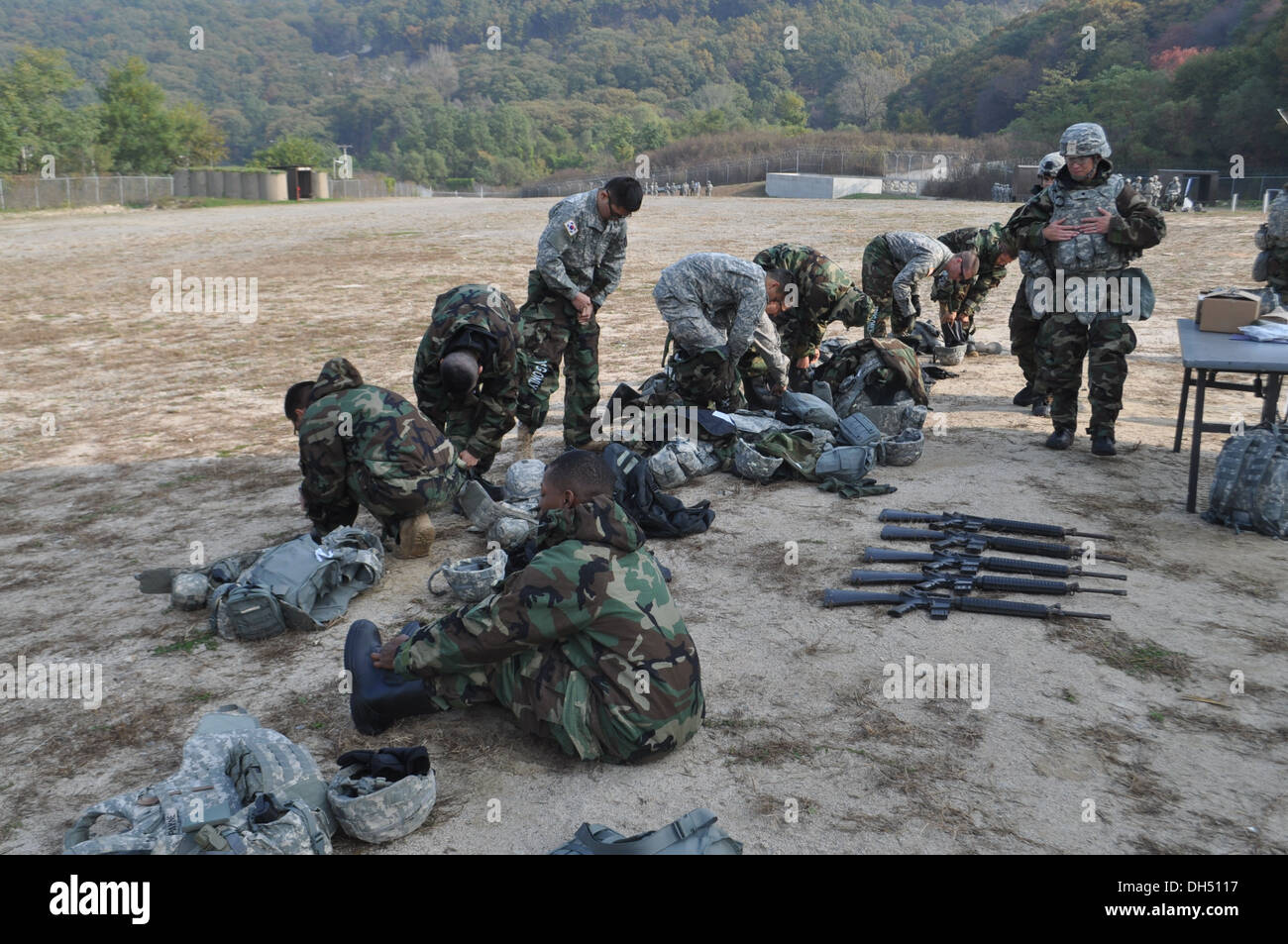 Soldiers from Headquarters and Headquarters Battery, 210th Fires Brigade, 2nd Infantry Division, put on mission oriented protective posture gear during chemical, biological, radiological, nuclear training on Camp Casey, South Korea, Oct. 24, 2013. The 210 Stock Photo