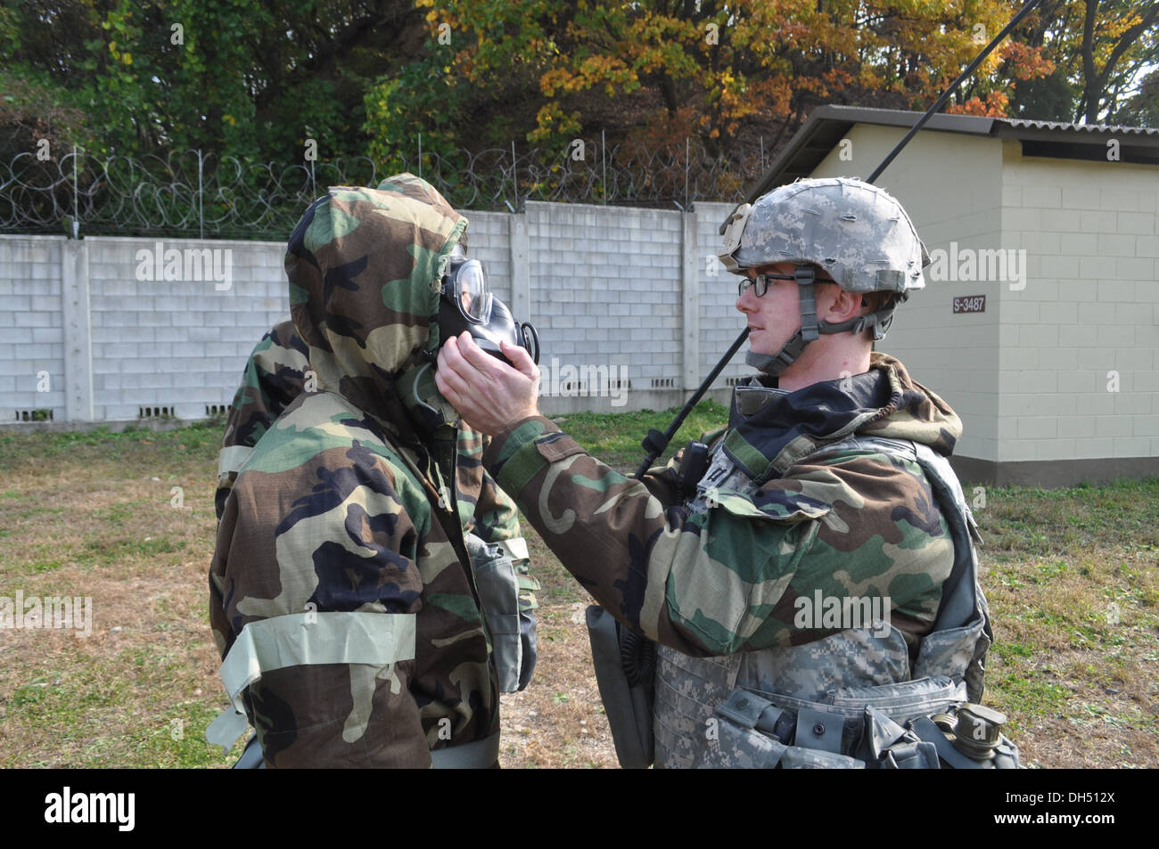 Capt. Daniel Standridge, from Abbeville, S.C., the 210th Fires Brigade chemical, biological, radiological, nuclear officer in charge, checks the protective mask status for Maj. Lee Geun-hyung, from Killeen, Texas, the brigade chaplain, during CBRN trainin Stock Photo