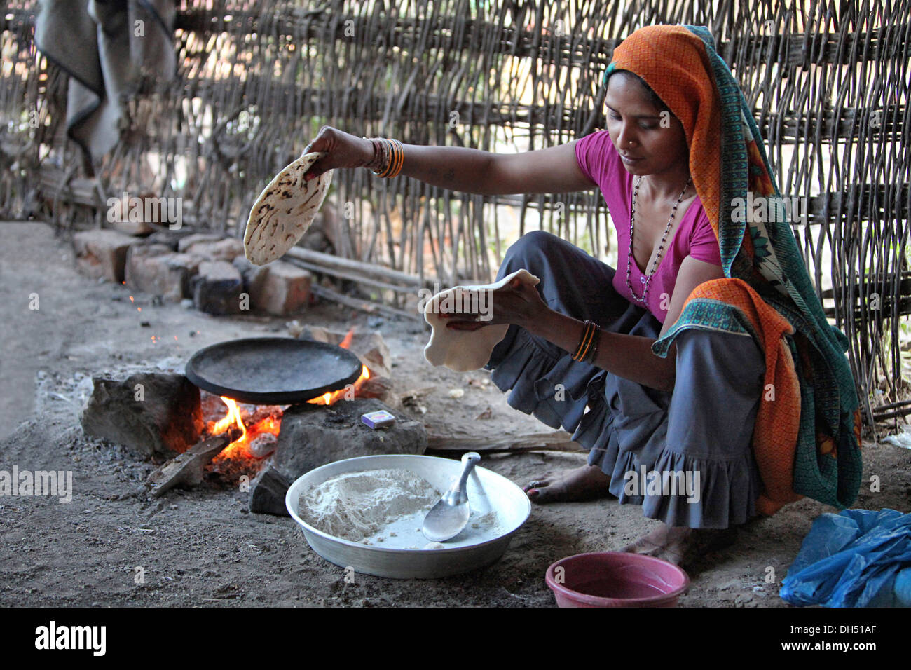 Tribal woman cooking food on hearth, Jhabua, Madhya Pradesh, India