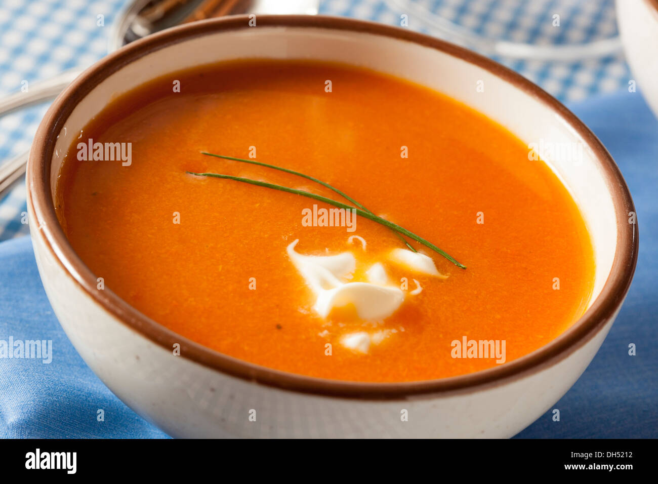 Homemade Orange Carrot Soup with Sour Cream Stock Photo