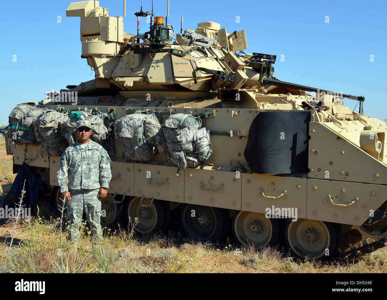 Staff Sgt. Thomas Moran, a section leader in Alpha Company, 1st Battalion, 6th Infantry Regiment, 2nd Brigade, 1st Armored Division, poses with a Bradley infantry fighting vehicle at Fort Bliss, Texas, Oct. 25, 2013. Soldiers at Network Integration Evalua Stock Photo