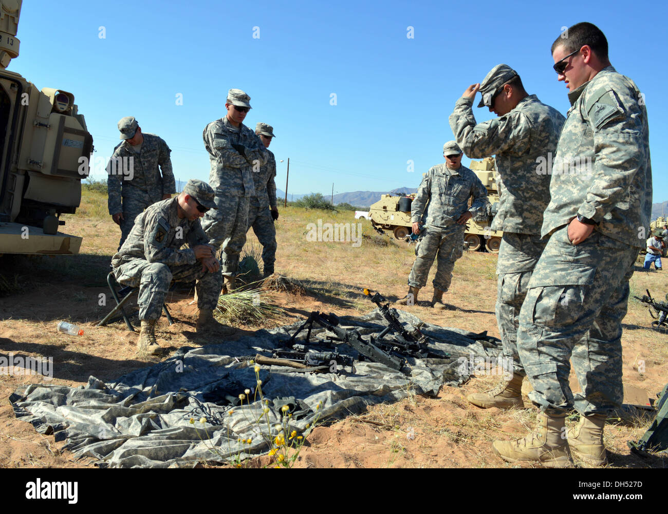 Sgt. Michael Cronin, a squad leader in Alpha Company, 1st Battalion, 6th Infantry Regiment, 2nd Brigade, 1st Armored Division, briefs Soldiers on assembly of various weapons at Fort Bliss, Texas, Oct. 25th, 2013. Soldiers at Network Integration Evaluation Stock Photo