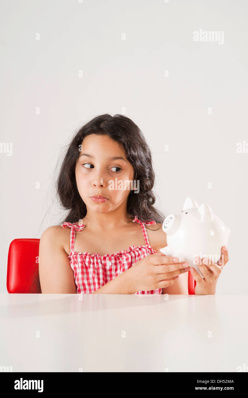 Girl holding a piggy bank Stock Photo - Alamy