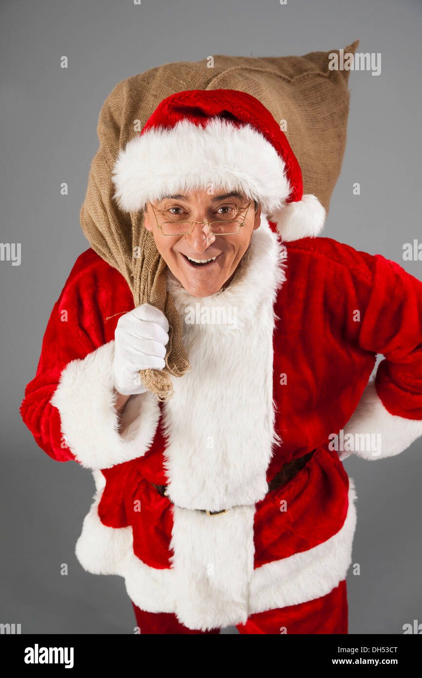 Santa Claus holding a sack Stock Photo - Alamy