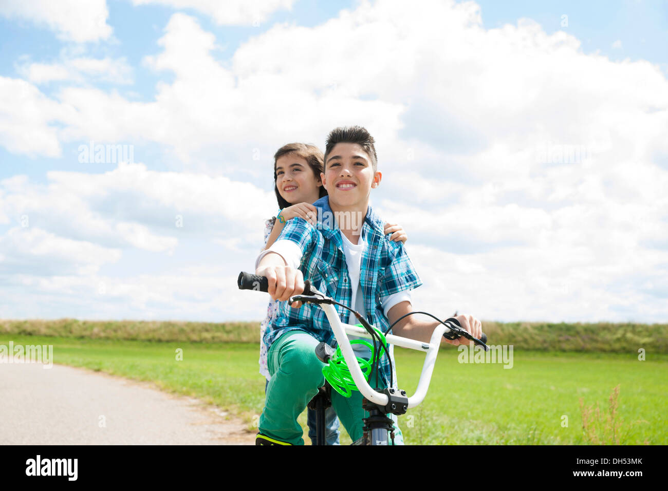 Girl riding top bike with boy