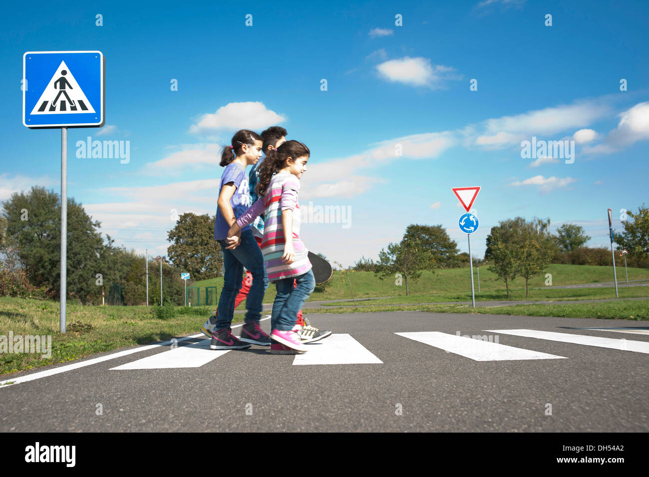 Children crossing a zebra crossing Stock Photo