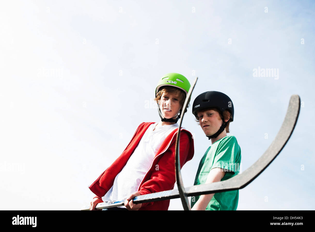 Two cool boys playing roller hockey with hockey sticks Stock Photo Alamy