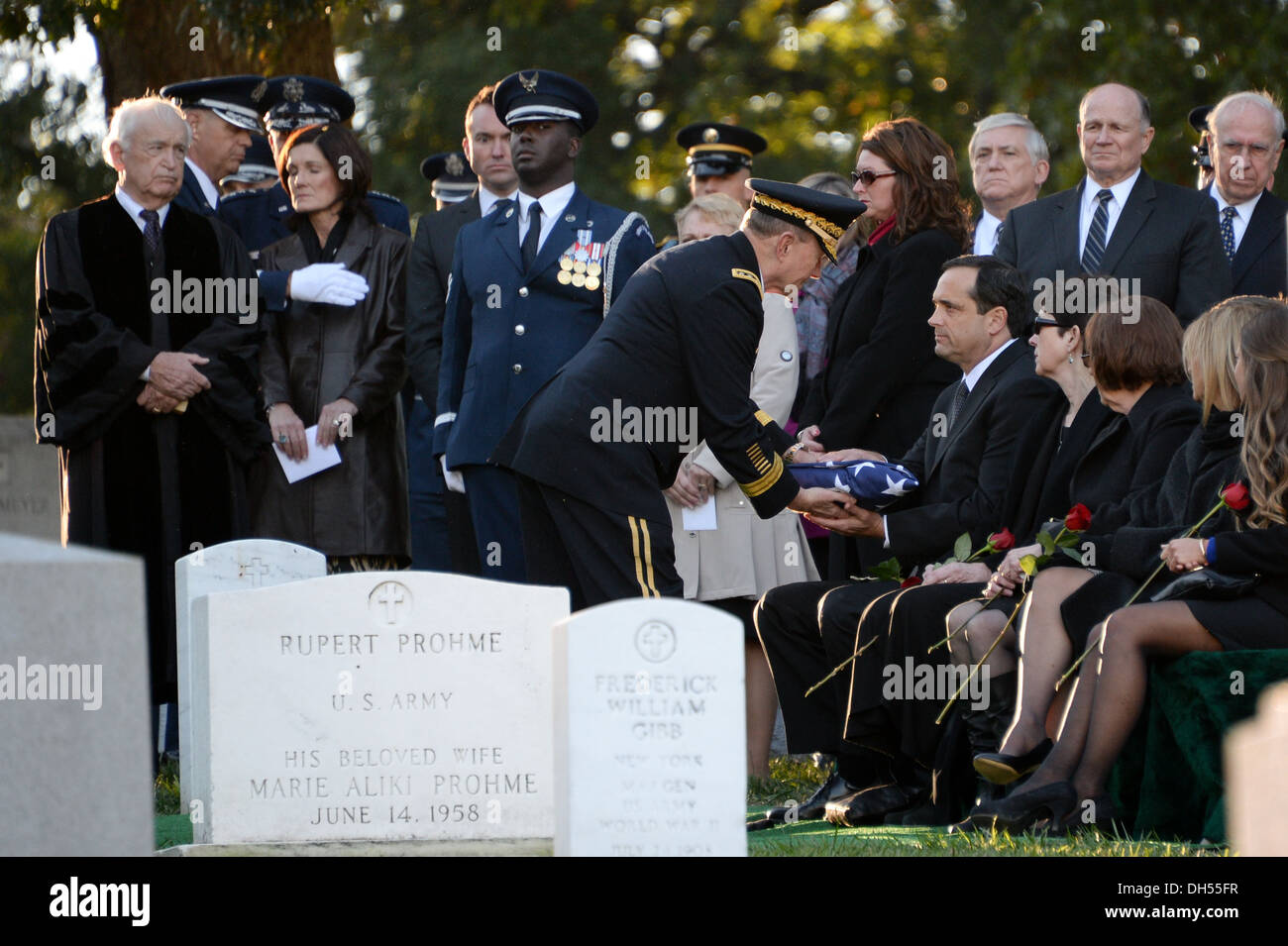 General Martin E. Dempsey, Chairman of the Joint Chiefs of Staff, hands a folded American flag to David Curtis Jones, son of Gen. David C. Jones, Former Chairman of Joint Chiefs, during his funeral at Arlington Cemetery in Arlington, Va., Oct. 25, 2013. Stock Photo