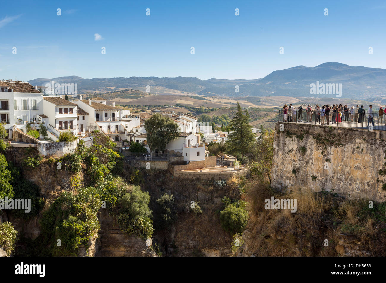 TOURISTS OVERLOOKING THE EL TAJO CANYON OR GORGE IN RONDA ANDALUCIA SPAIN Stock Photo