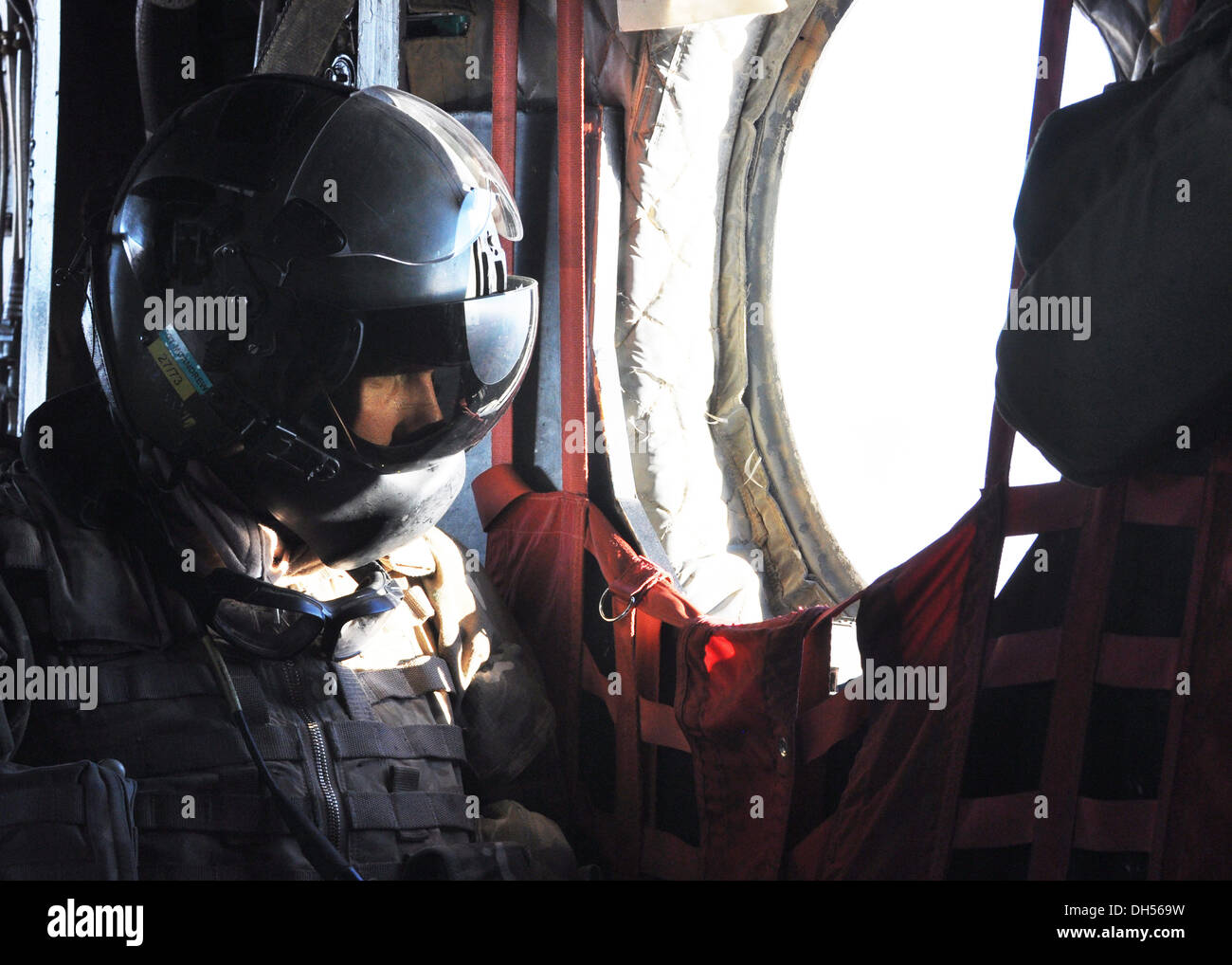 WINDOW WATCHER -- A crew member of a British CH-47 Chinook peers out the window after leaving Camp Leatherneck, Helmand Province, Afghanistan, en route to Main Operating Base LashKar Gah. Stock Photo