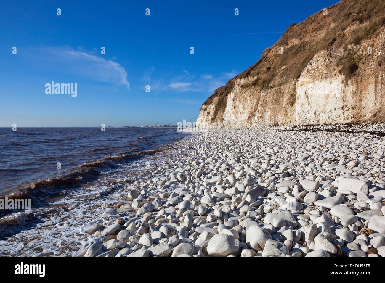 Waves lapping the white pebbles and limestone cliffs of Bridlington bay at Danes dyke on Yorkshire's East coast. Stock Photo