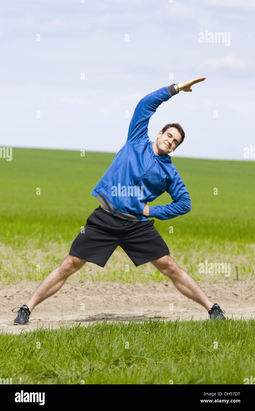 man stand and strech the side Stock Photo