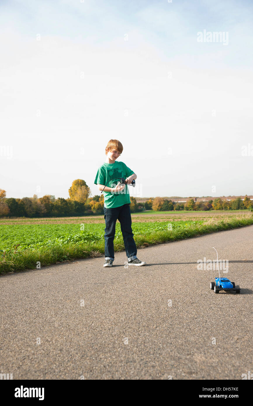 Boy playing with his radio-controlled model car Stock Photo