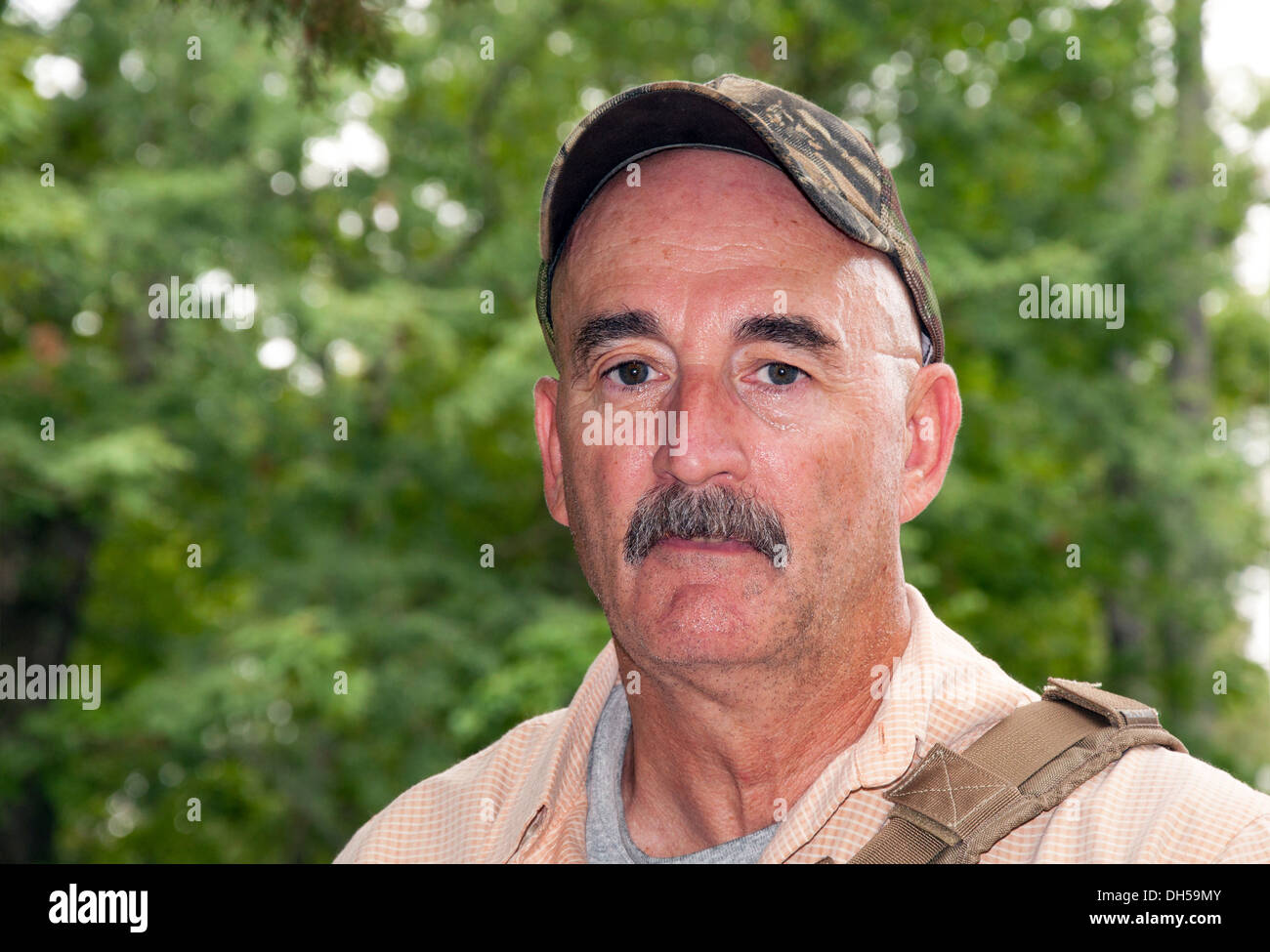 Middle-aged man outdoors, hiking in woods in summer Stock Photo