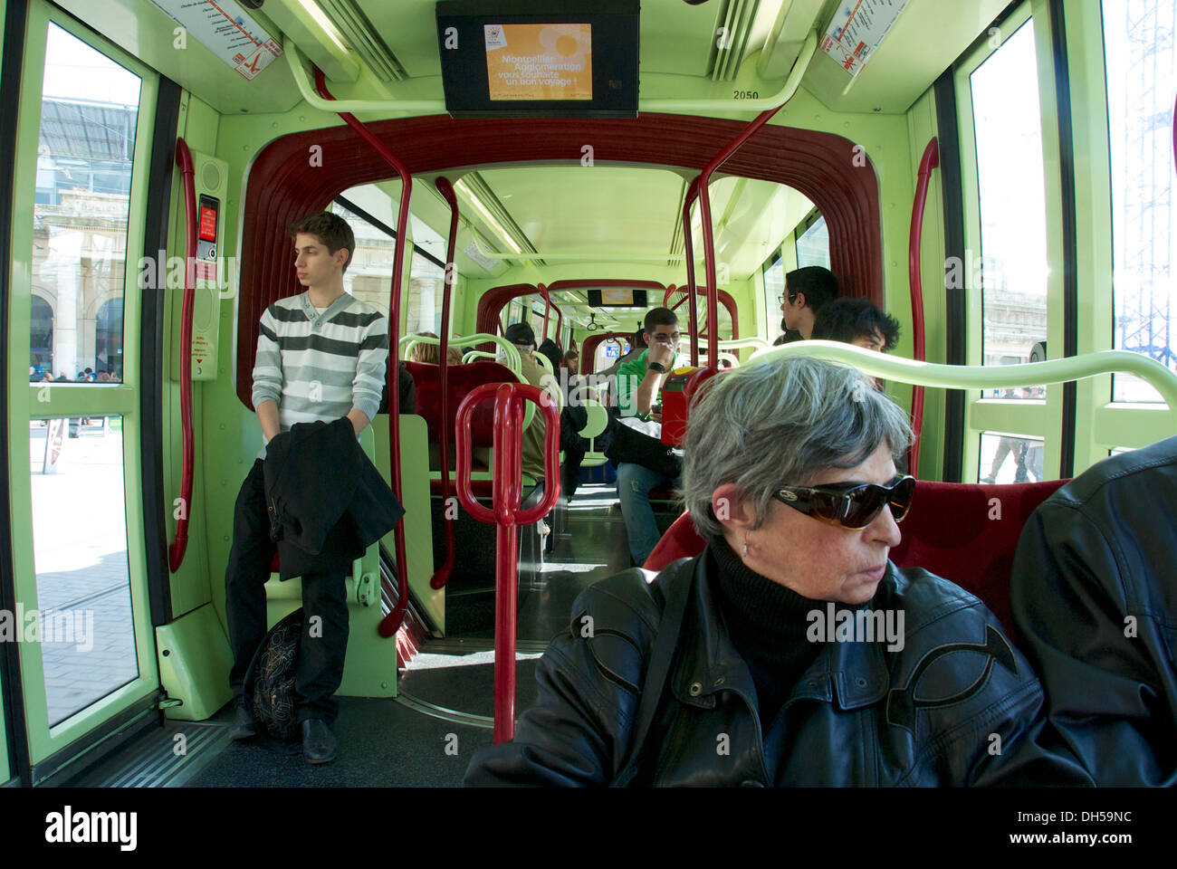 French woman on board the Montpelier tram heading west towards Meze in France Stock Photo