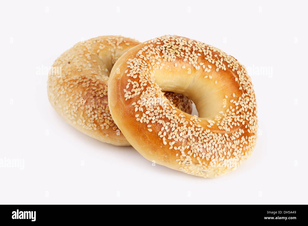 two sesame Bagels on white background Stock Photo