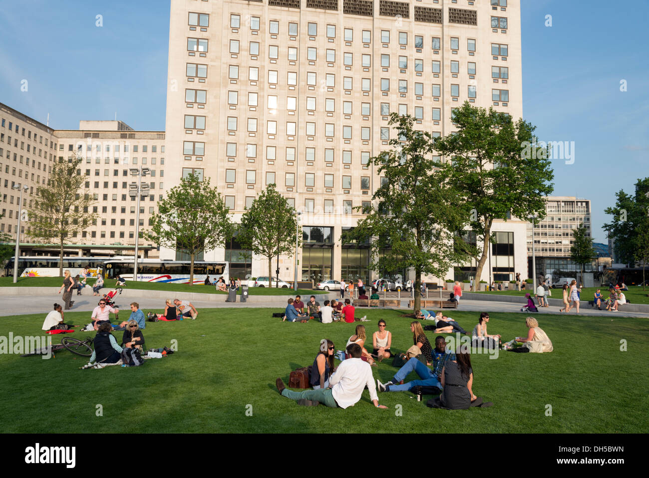 People relaxing in Jubilee Gardens on the South Bank, London, England, UK Stock Photo