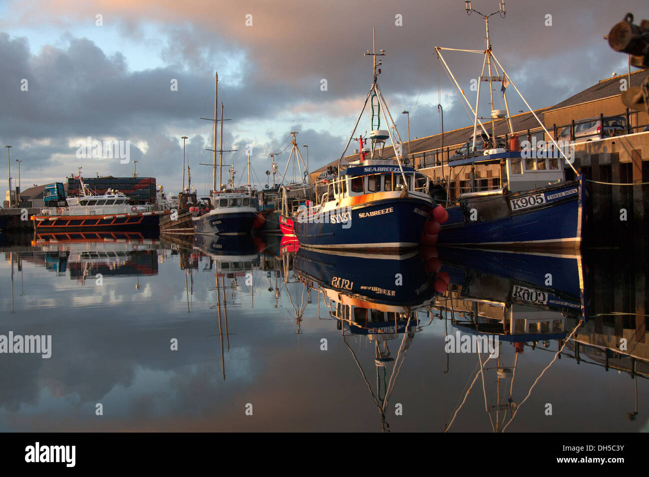 Islands of Orkney, Scotland. Picturesque early evening view of fishing boats tied-up alongside Kirkwall’s harbour basin. Stock Photo
