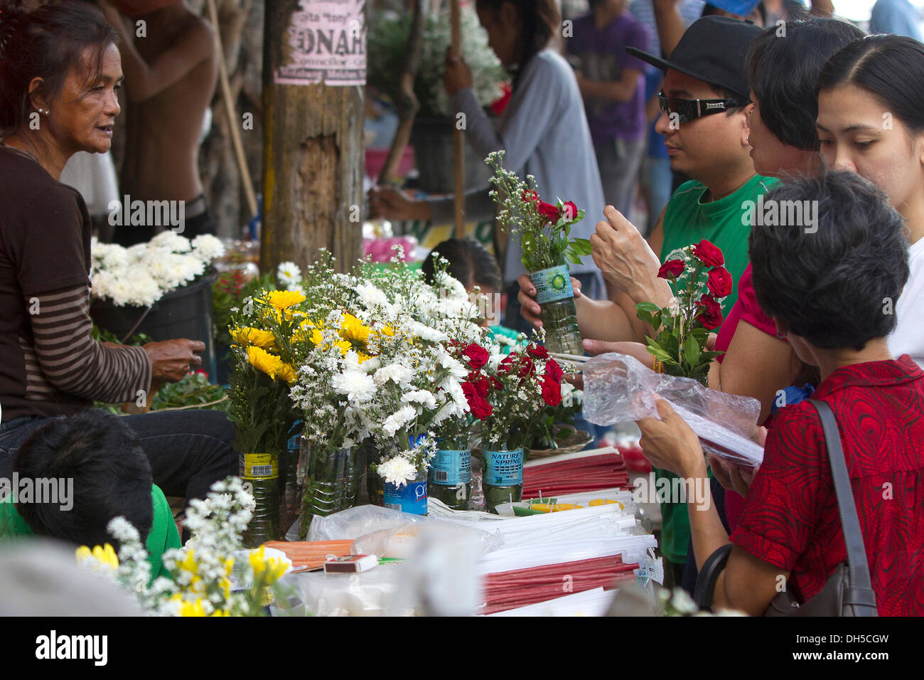 Carreta Cemetery,Cebu City,Philippines. 1st Nov, 2013. All Saints Day in the Philippines. A time for Catholic Filipino's to remember and pay homage to their loved ones. Here at the entrance to Carreta Cemetery Cebu City,relatives buy flowers from the many vendors alongside the entrance. Credit:  imagegallery2/Alamy Live News Stock Photo