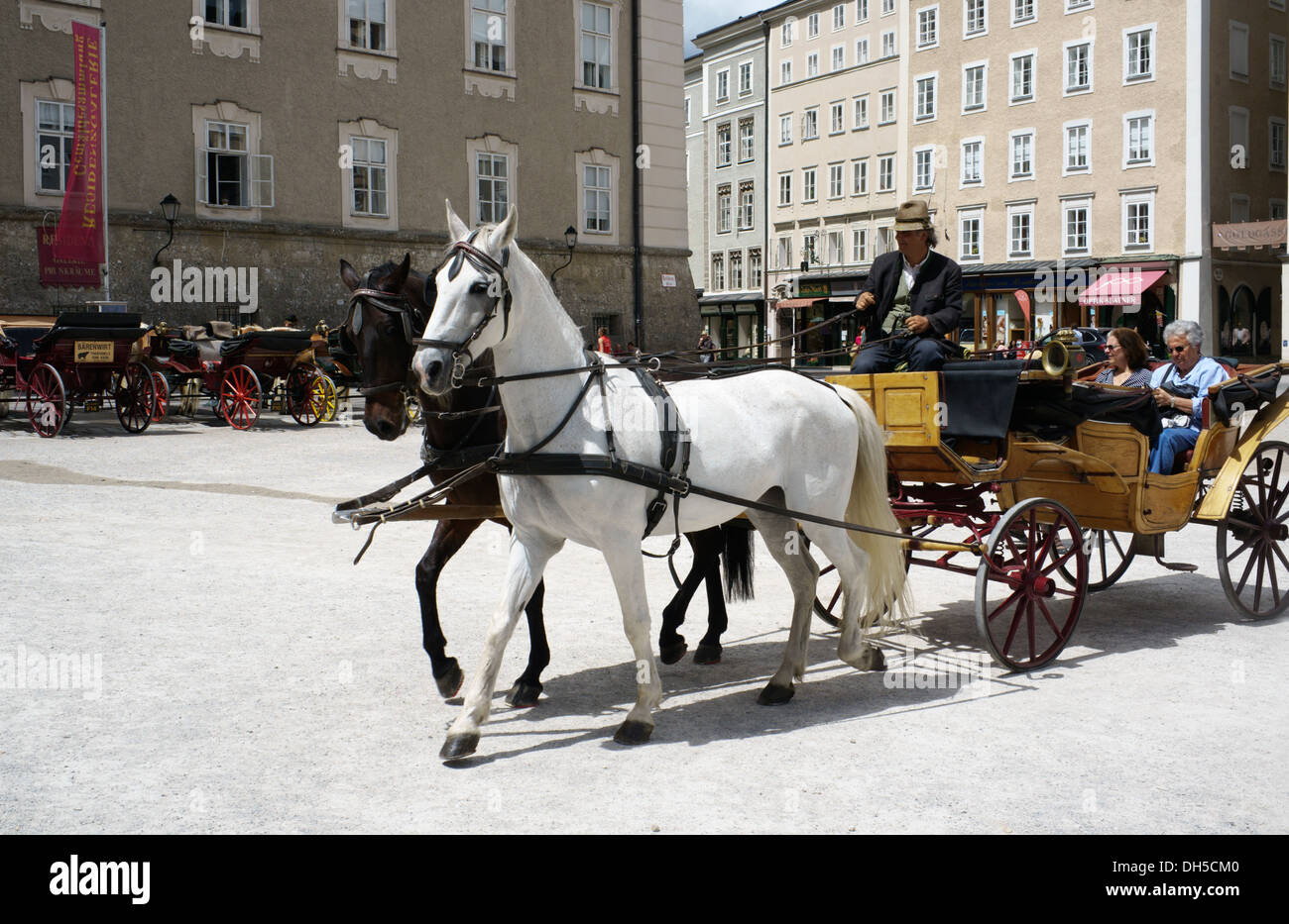 Salzburg, Austria Horse drawn Fiaker carriage ride in Altstadt (old town) Salzburg, Austria. Photo May 2013. Stock Photo