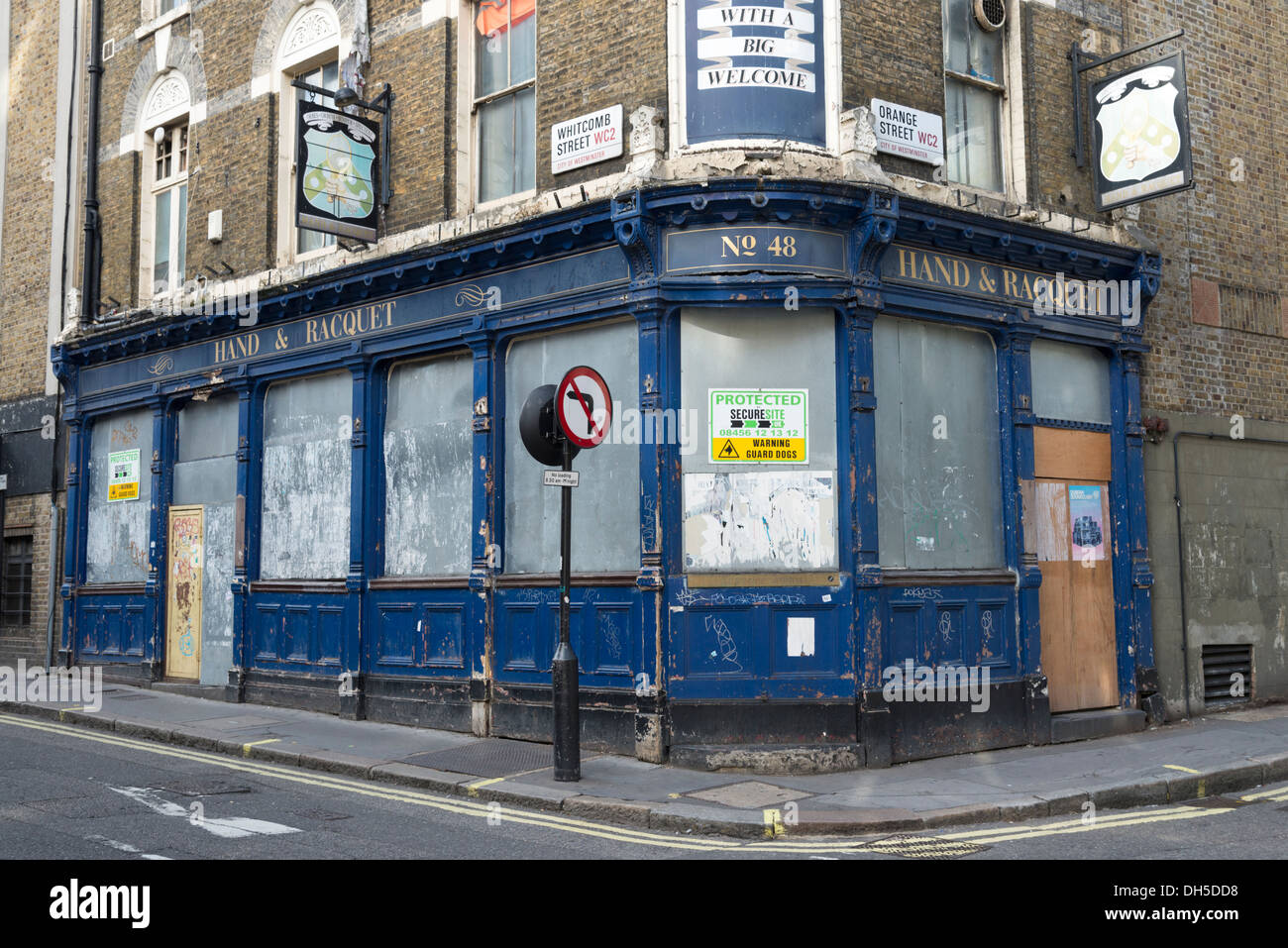 The Hand & Racquet boarded up pub which has closed down, Whitcomb Street, London, UK Stock Photo