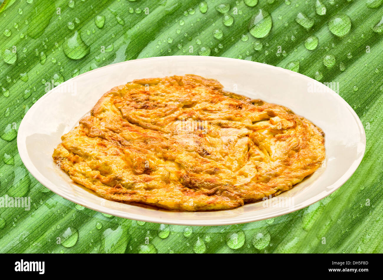 Plain egg omelette on green nature Stock Photo