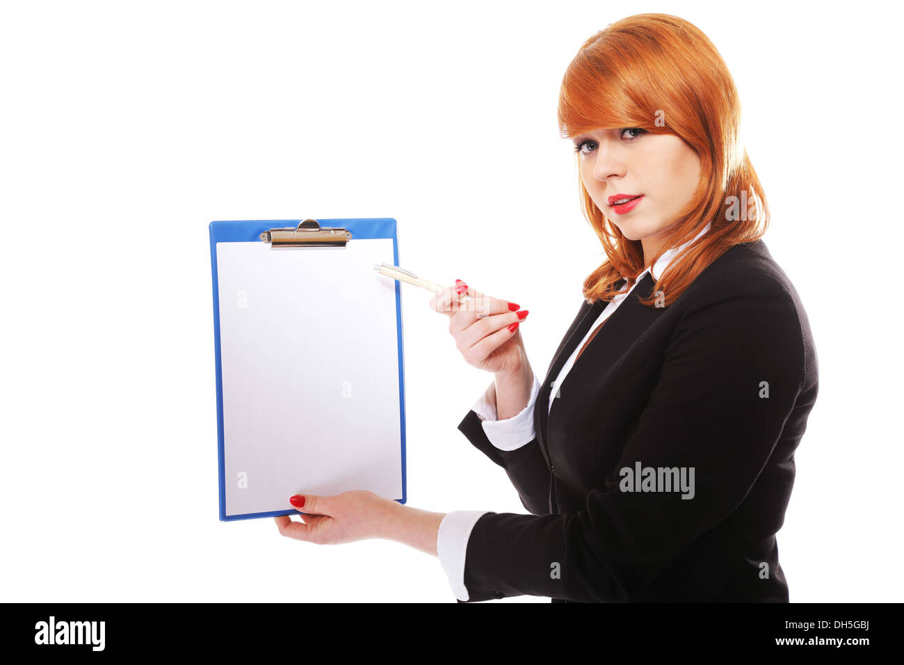 Redhaired businesswoman holds clipboard with blank and points with pen. Isolated on white background Stock Photo
