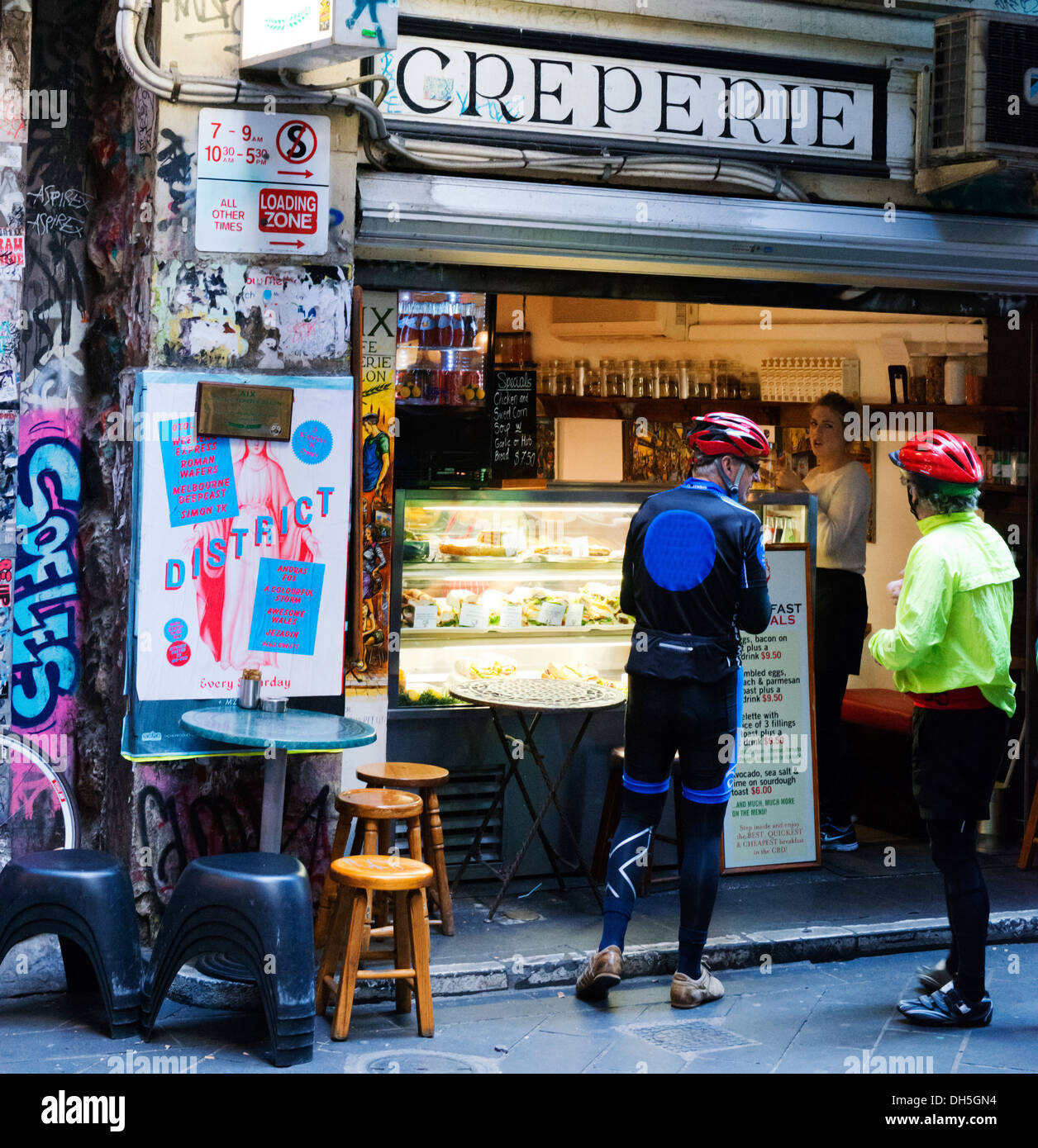 Cyclists line up for a crepe at a Creperie in one of Melbourne's famed lanes. Stock Photo