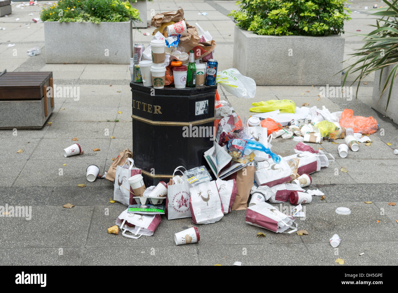 Takeaway bags and drinks containers overflowing from litter bin, London, England, UK Stock Photo