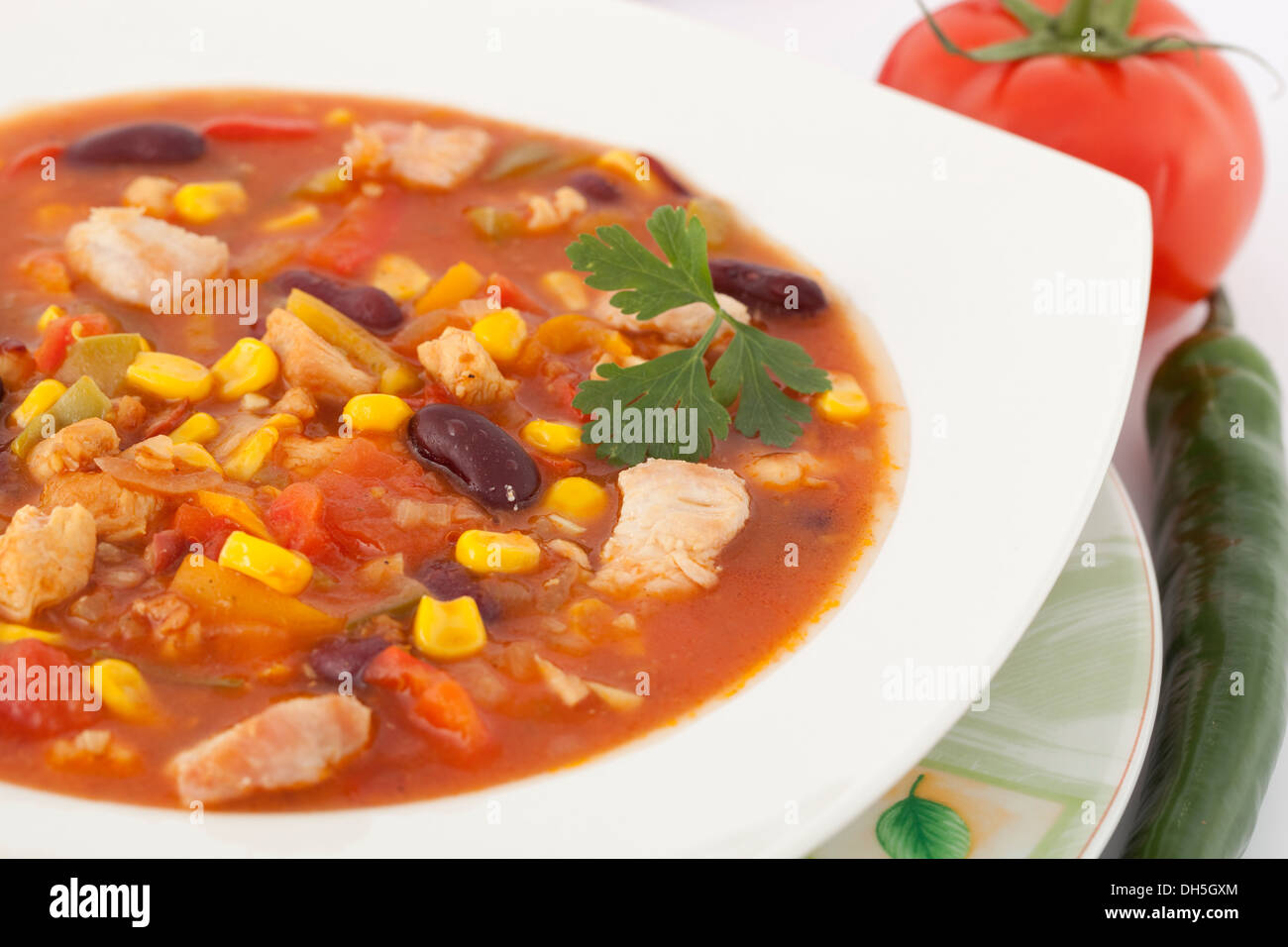 strongly spicy Mexican soup with vegetables in plate Stock Photo