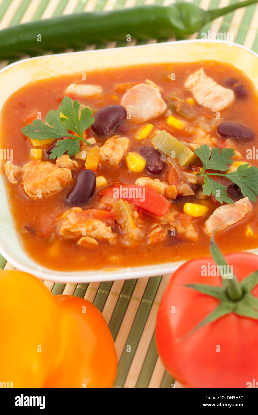 strongly spicy Mexican soup with vegetables in bowl Stock Photo