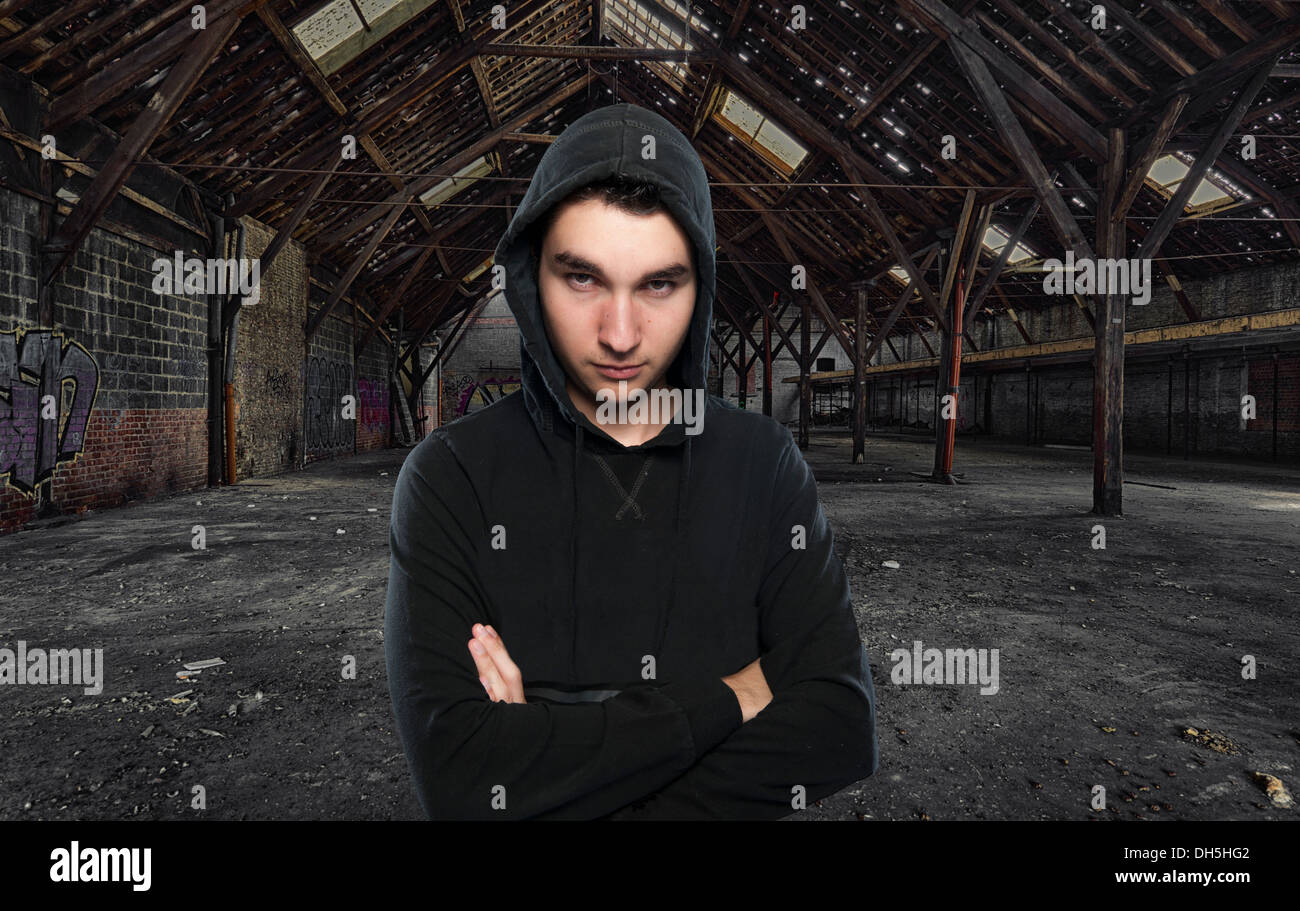 teen boy in an abandoned hall with graffiti Stock Photo