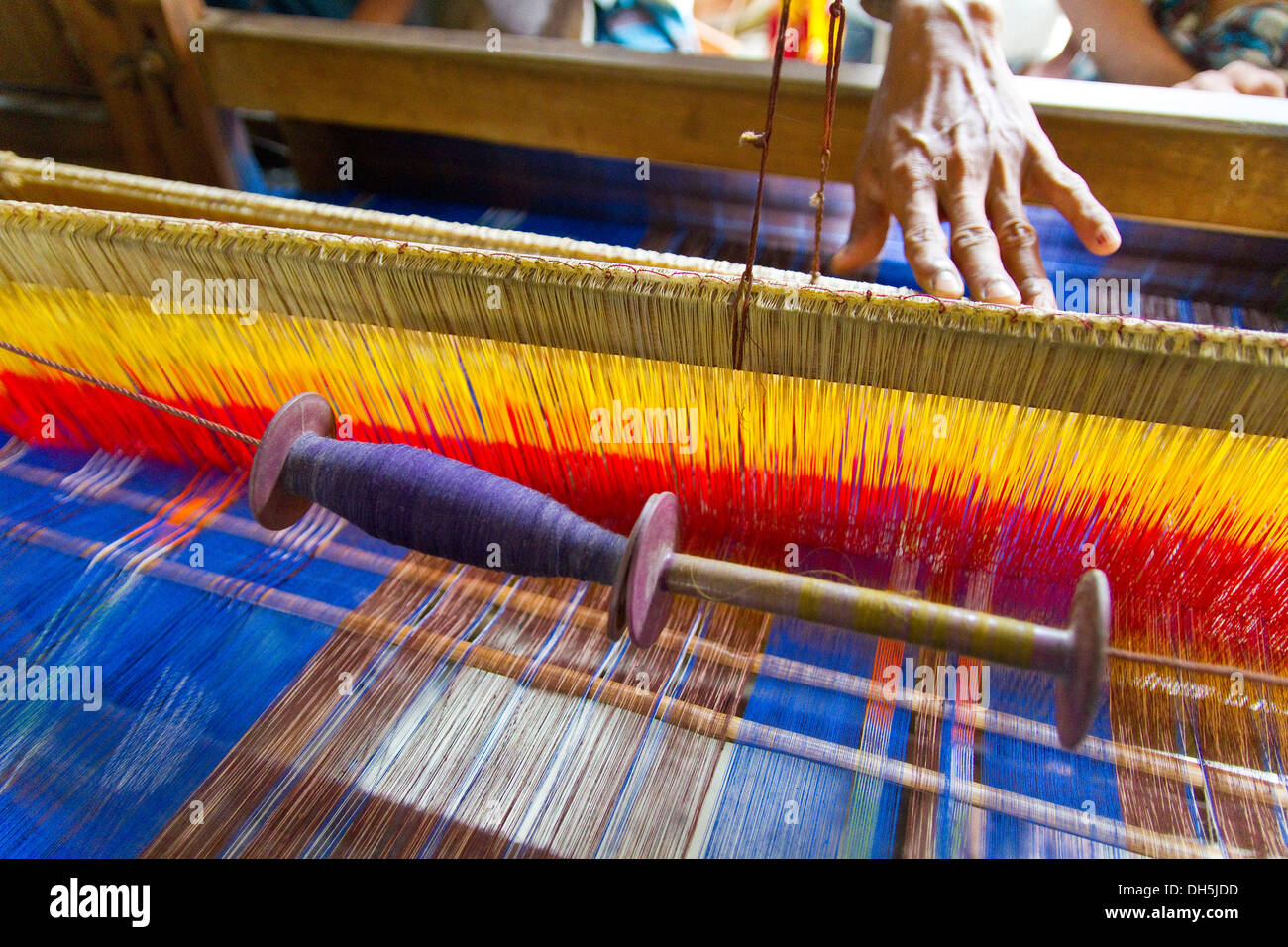 Hand at the loom, the establishment of the loom takes a day, 2300 threads have to be pulled twice by hand through eyelets Stock Photo
